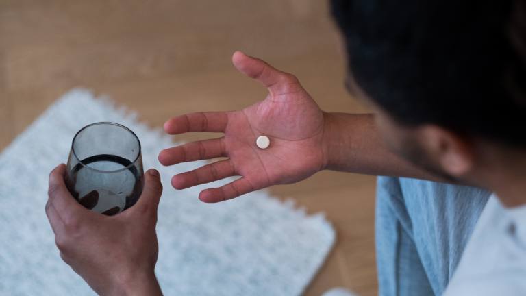 Homem tomando medicamentos para impotência sexual